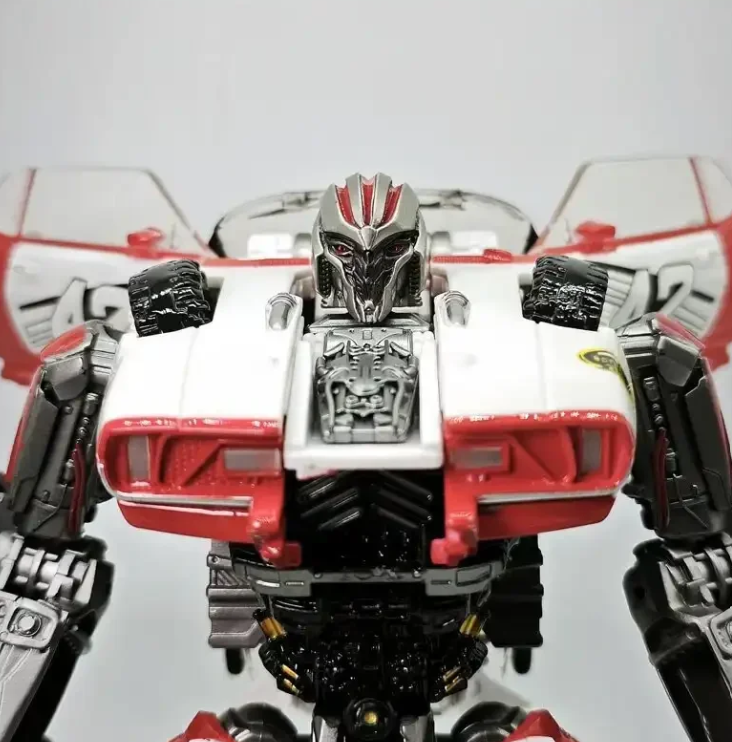 Close-up of Decepticon Shatter metallic face sculpt and muscle car hood chest grille