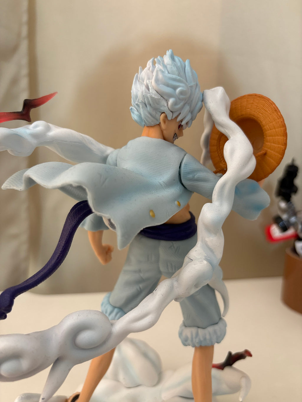 Detailed view of Gear 5 Luffy defined torso muscles, X shaped chest scar, and purple waist sash