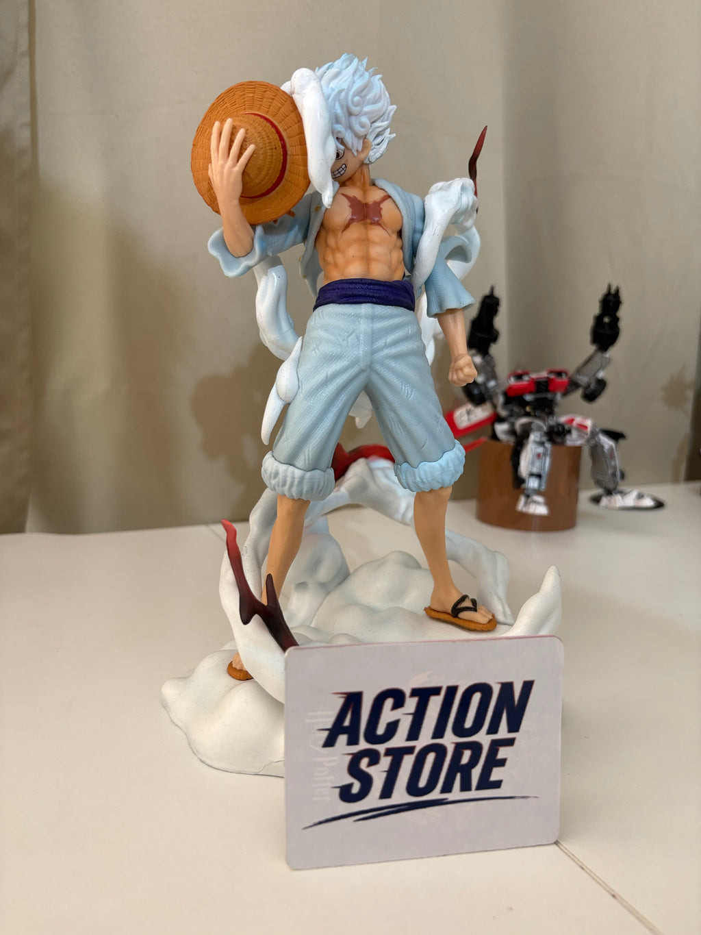 One Piece Luffy Gear 5 Sun God Nika action figure holding straw hat surrounded by white cloud aura on cloud base