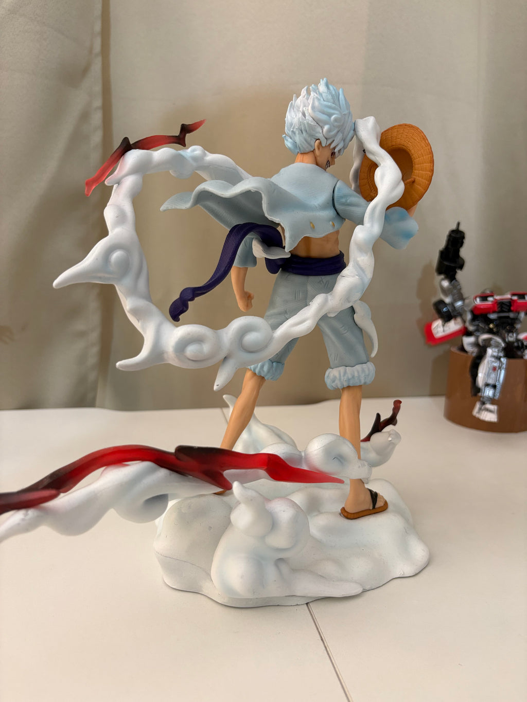 Rear back view of Luffy Gear 5 figure showcasing floating white Hagoromo cloud scarf and sandal straps