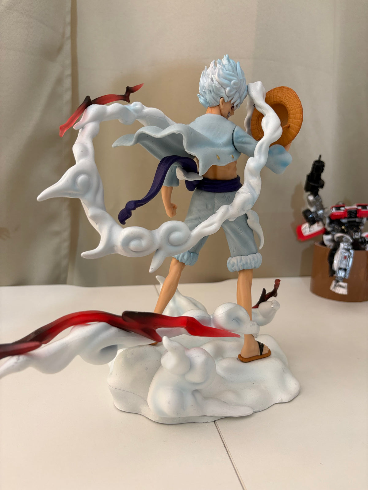Rear back view of Luffy Gear 5 figure showcasing floating white Hagoromo cloud scarf and sandal straps